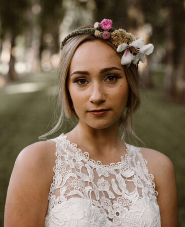 wedding updo with flowers for bride by whitney evans beauty