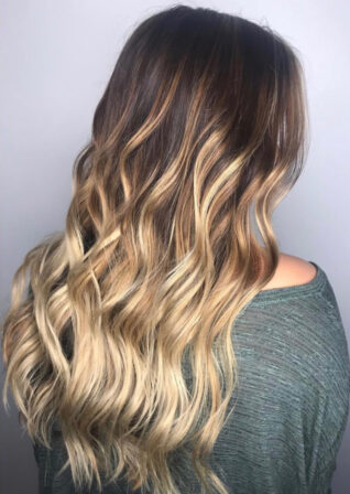 Long brunette hair with blonde balayage in loose waves, back view