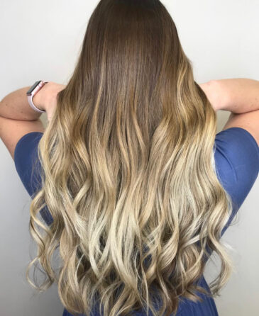 Long bronde balayage waves blending brown roots into light blonde ends
