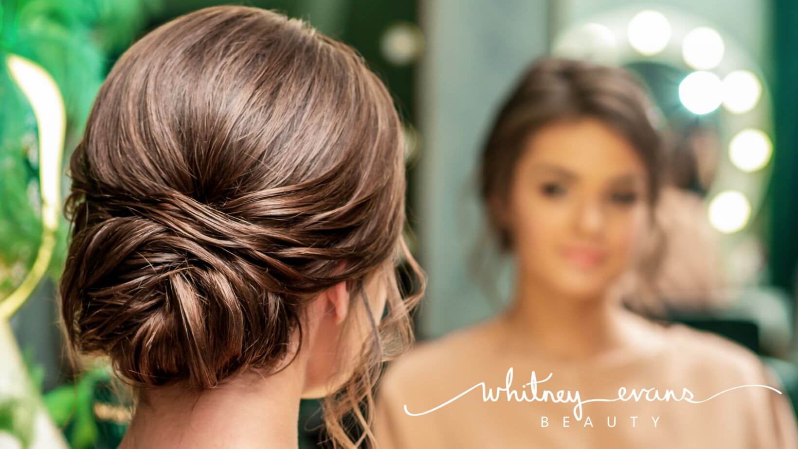 Brunette hair styled in a low bun by Whitney Evans Beauty
