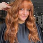 Copper red color with curtain bangs and soft waves by Whitney Evans Beauty