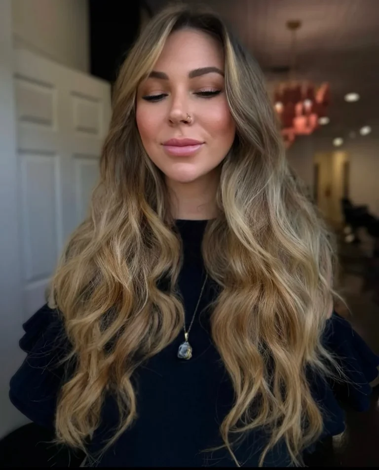 Long honey blonde balayage waves with added length and fullness from extensions