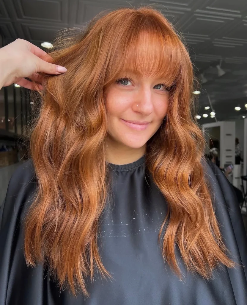 Copper red color with curtain bangs and soft waves by Whitney Evans Beauty