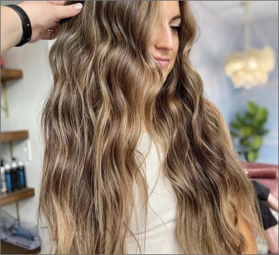 Long brunette waves with soft caramel blonde balayage